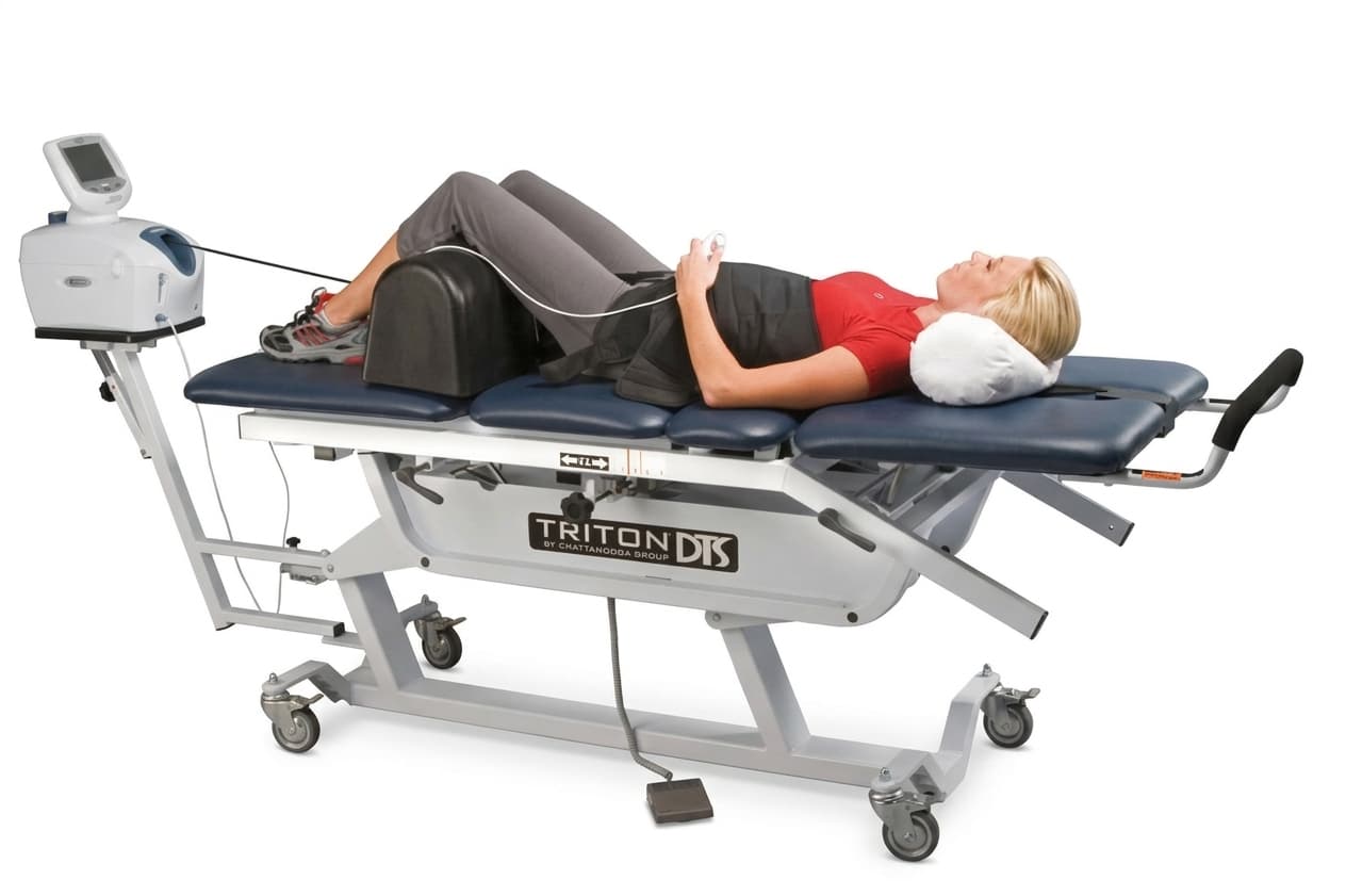 Patient reclined on a spinal decompression traction table during treatment